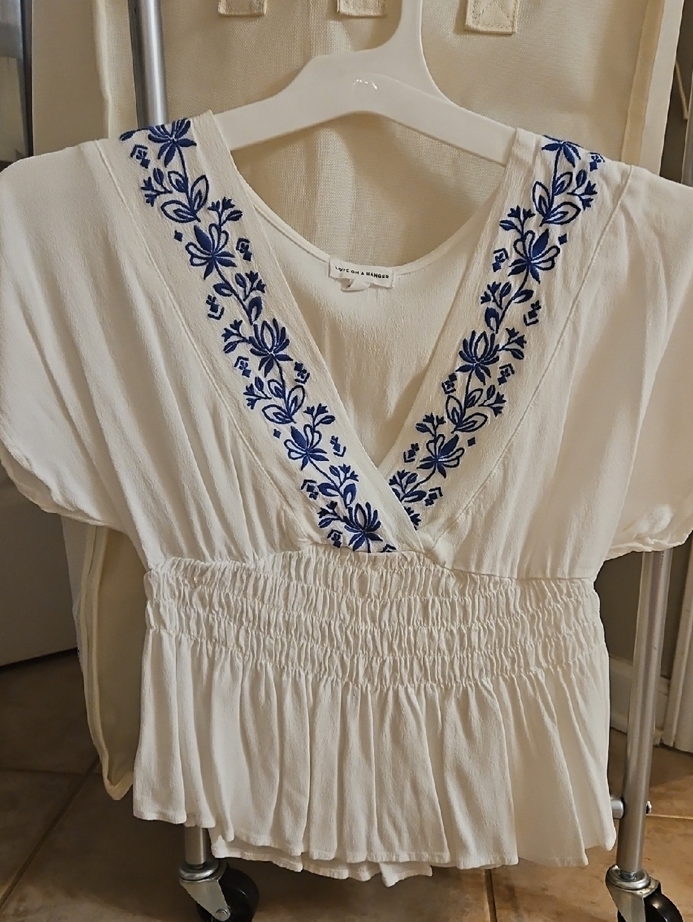 love on a hanger White V-Neck Peplum Top with Blue Floral Embroidery